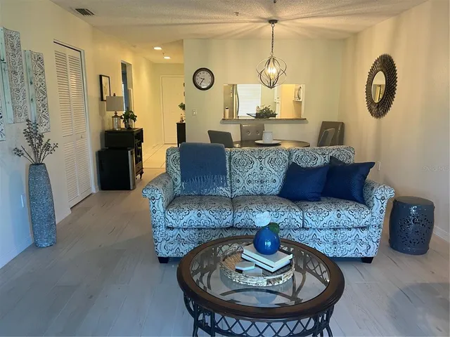 a living room with furniture and a large mirror