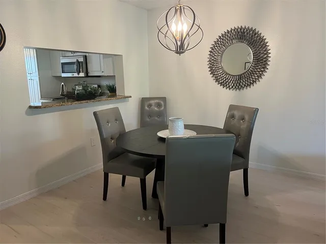 a dining room with furniture and a mirror