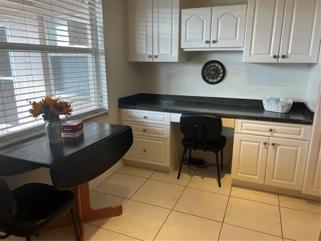a kitchen with a sink cabinets and window