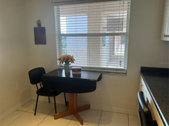 a dining room with furniture and window