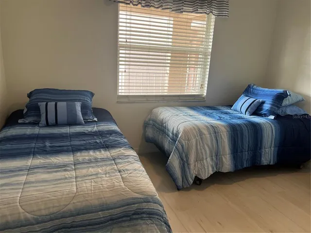 a bedroom with a bed and window