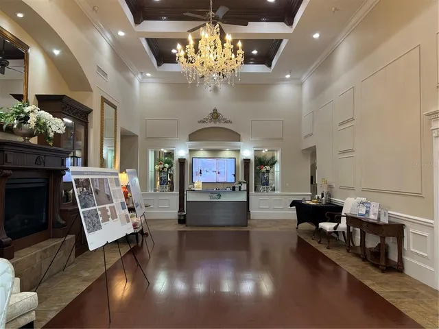 a living room with fireplace furniture and a chandelier