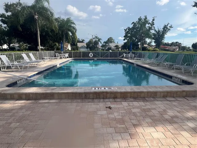 a view of a backyard with swimming pool