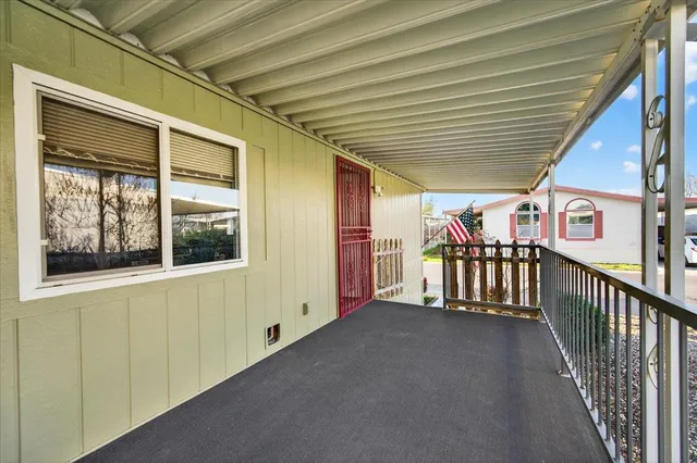 a view of a house with backyard and trees