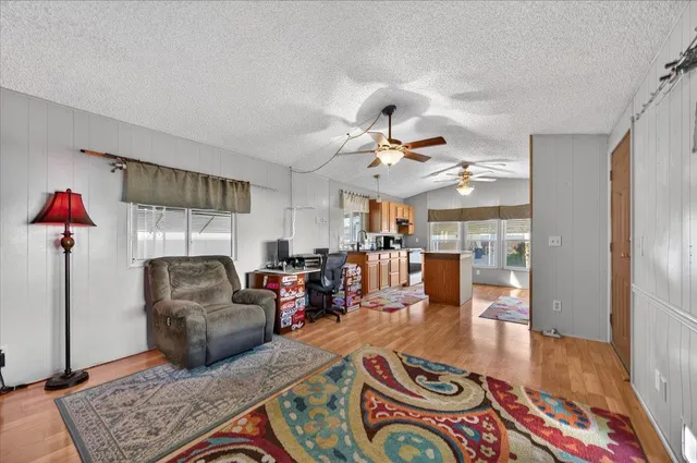 a kitchen with stainless steel appliances granite countertop a refrigerator a stove top oven a sink and dishwasher