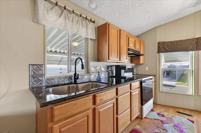 a kitchen with stainless steel appliances a refrigerator and cabinets