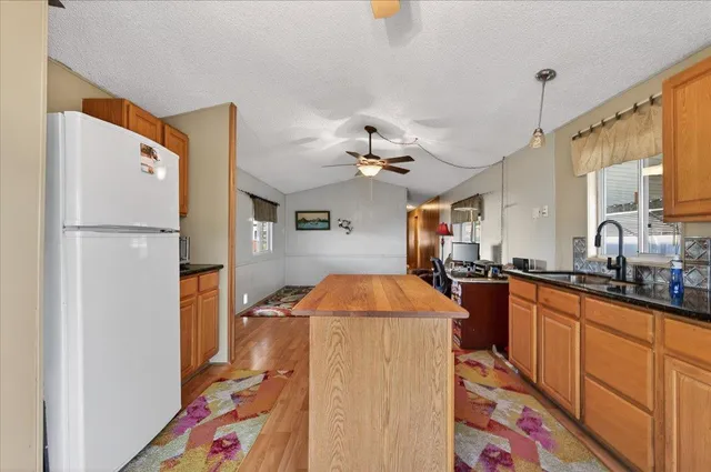 a kitchen with stainless steel appliances granite countertop a stove a sink and a refrigerator