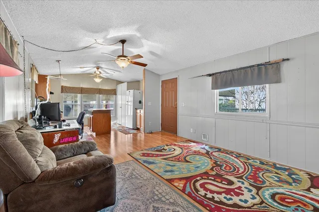 a room with a baby crib furniture a lamp and entryway
