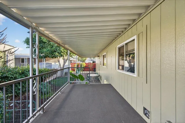 a view of a chairs and table in the balcony