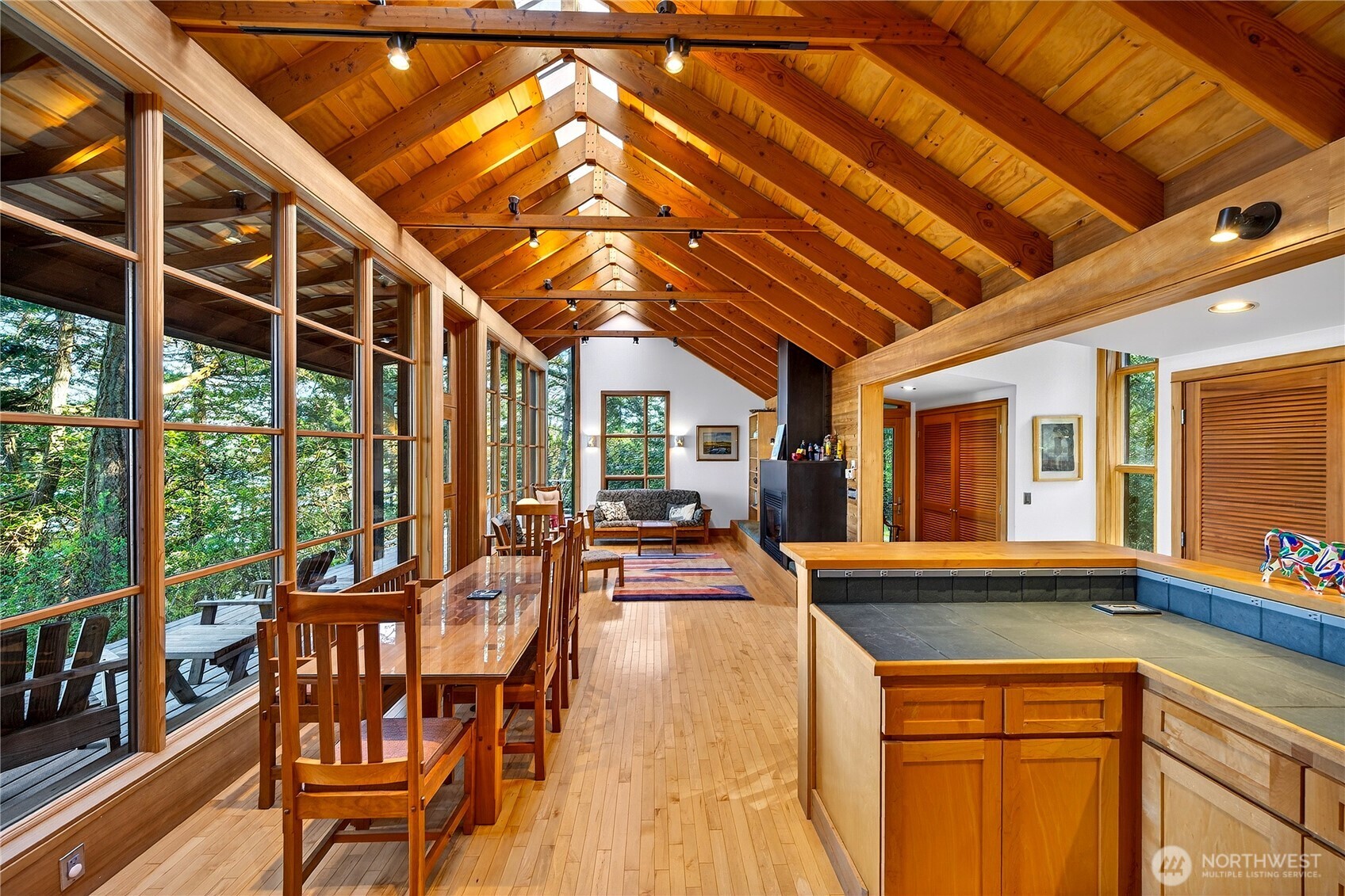 7457 Holiday Boulevard Anacortes, WA 98221 - Photo 11 of 23 a view of a patio with table and chairs and wooden floor