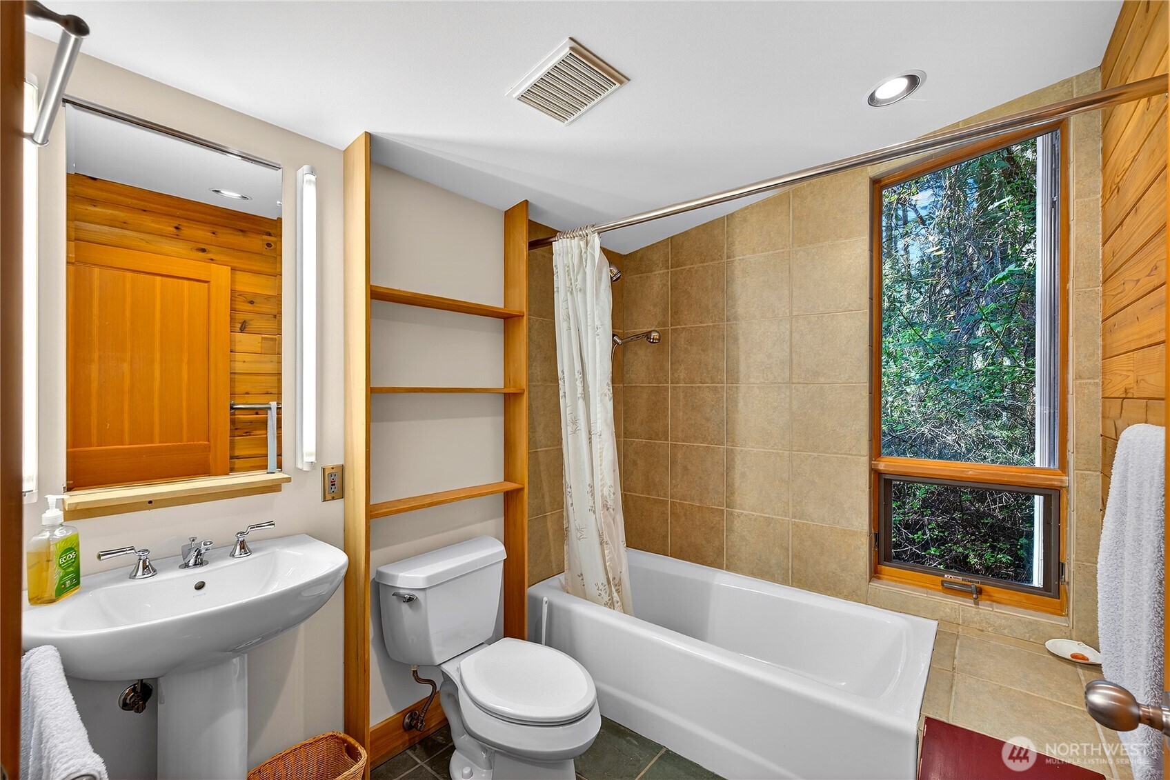 7457 Holiday Boulevard Anacortes, WA 98221 - Photo 13 of 23 a bathroom with a bathtub toilet and sink