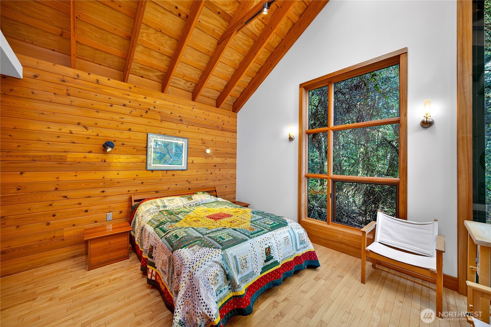 7457 Holiday Boulevard Anacortes, WA 98221 - Photo 15 of 23 a bedroom with a bed and wooden floor