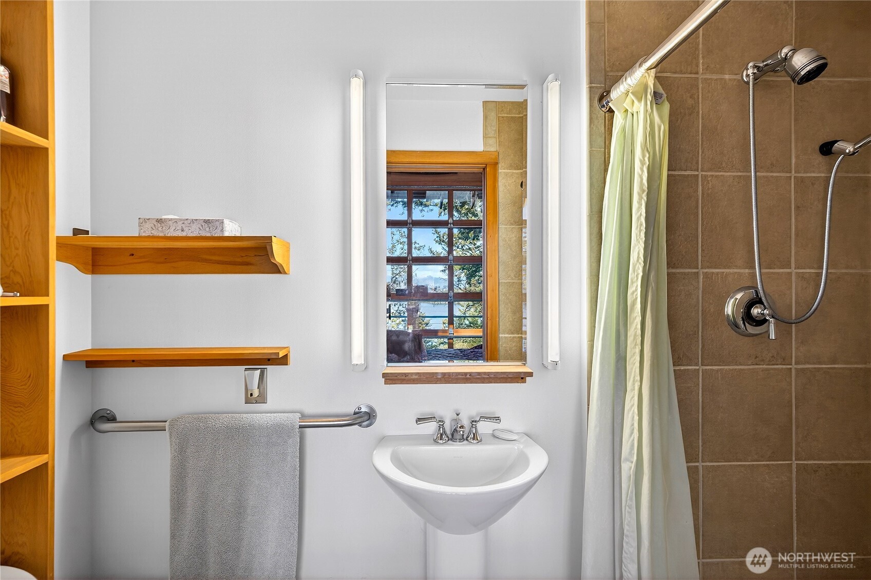7457 Holiday Boulevard Anacortes, WA 98221 - Photo 17 of 23 a bathroom with a sink a toilet and shower