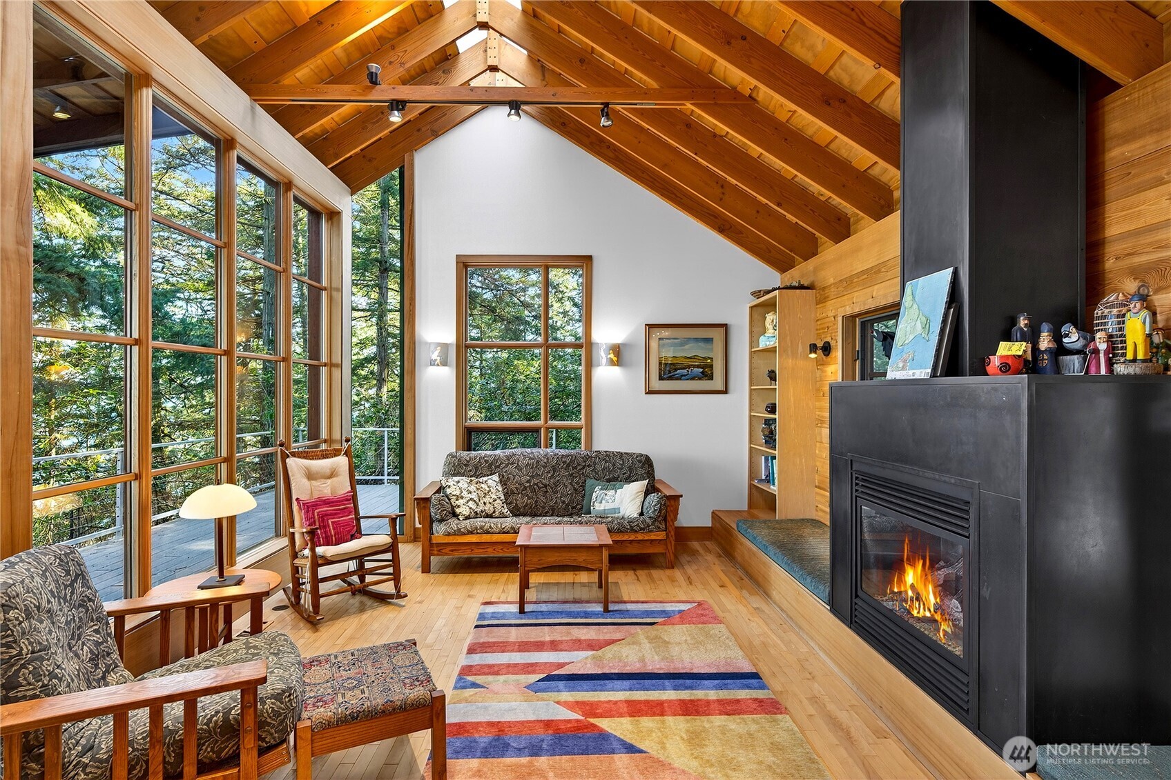 7457 Holiday Boulevard Anacortes, WA 98221 - Photo 2 of 23 a living room with furniture a flat screen tv and a fireplace