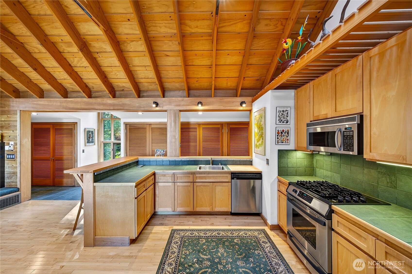 7457 Holiday Boulevard Anacortes, WA 98221 - Photo 7 of 23 a kitchen with stainless steel appliances granite countertop a stove and a sink