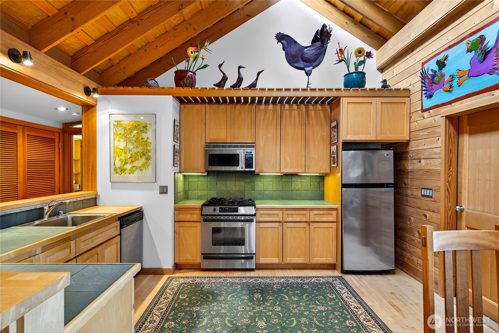 7457 Holiday Boulevard Anacortes, WA 98221 - Photo 8 of 23 a kitchen with stainless steel appliances granite countertop a stove a sink and a microwave