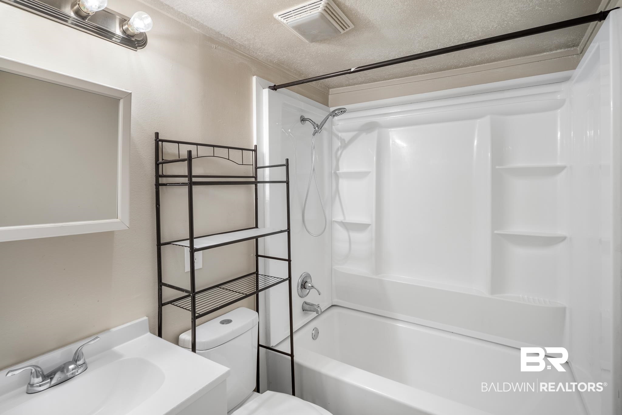401 Gaston Street Mobile, AL 36603 - Photo 11 of 17 Full bathroom with shower / bathtub combination, vanity, a textured ceiling, and toilet