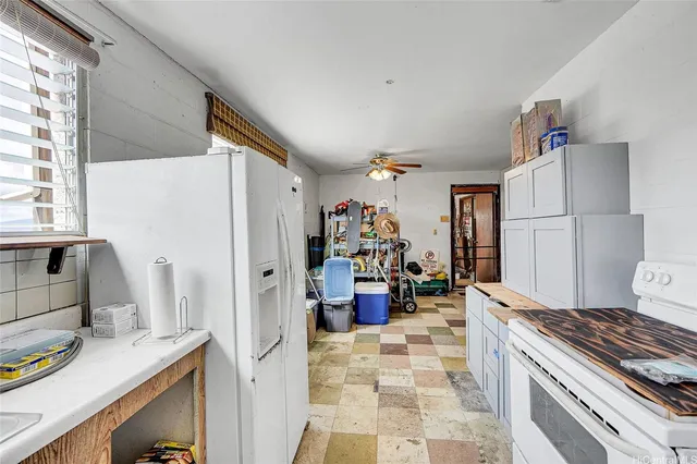 a kitchen with a refrigerator and a sink