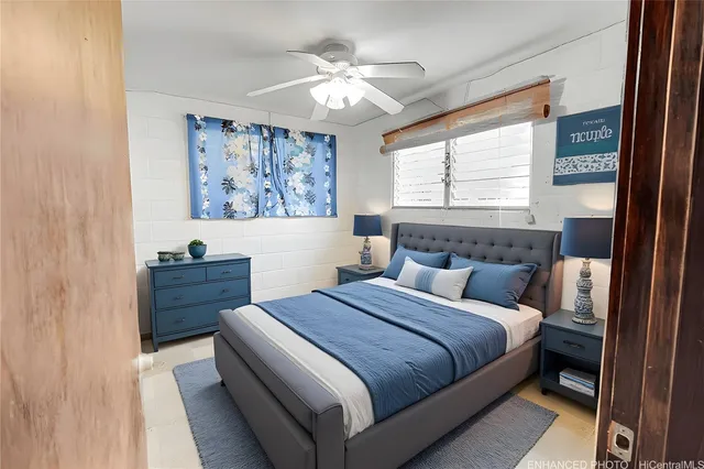 a bed room with a bed and a painting on the wall