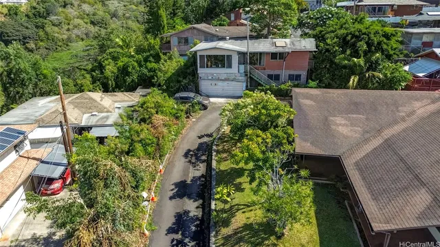 an aerial view of a house with a yard and potted plants