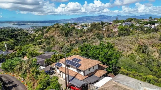 an aerial view of a houses with a yard