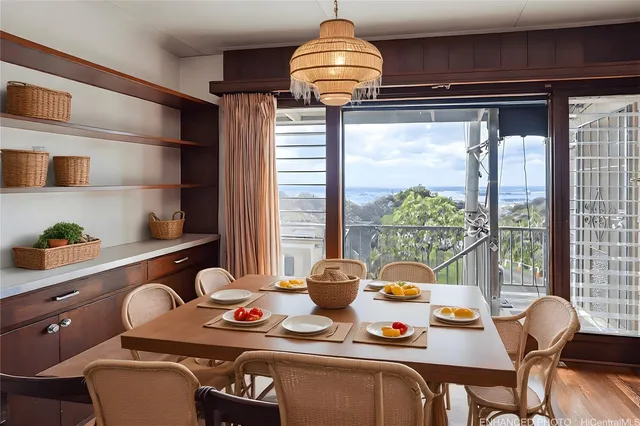 a dining room with furniture and a window