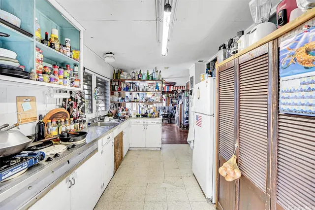 a kitchen with refrigerator and cabinets