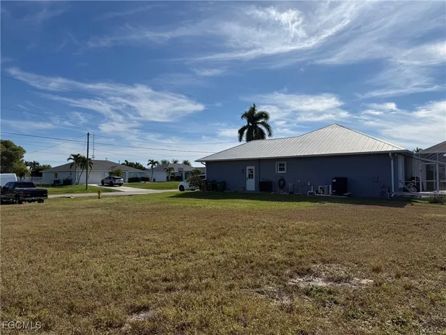 a front view of house with yard and car parked