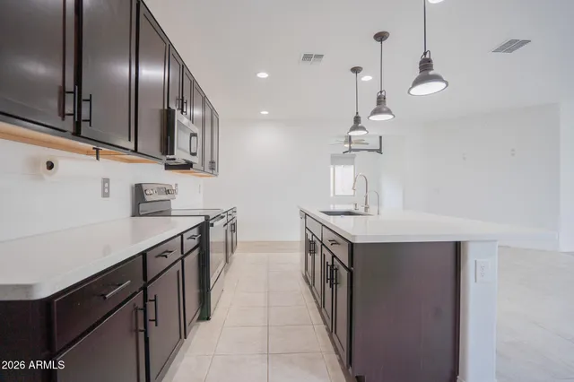 a kitchen with stainless steel appliances granite countertop a sink and stove