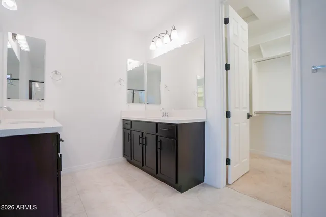a bathroom with a double vanity sink and a mirror