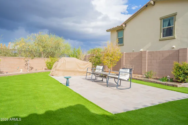 a view of a patio with table and chairs and potted plants