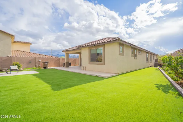 a view of a big house with a big yard and a large tree