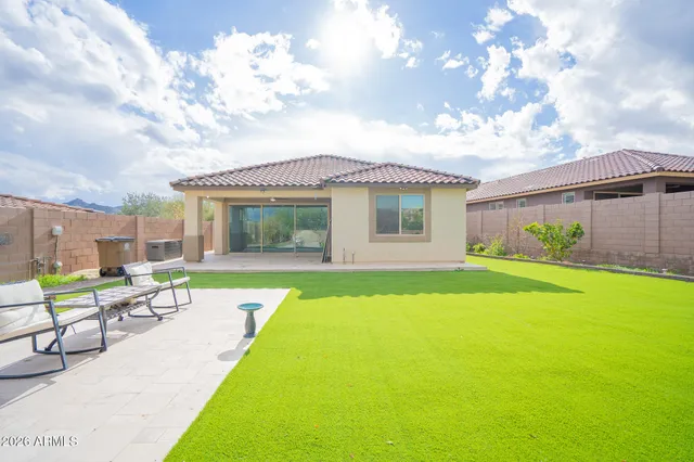 a view of house with swimming pool and furniture