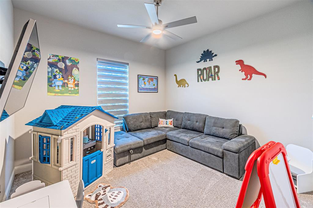 1009 Henry Way Springtown, TX 76082 - Photo 33 of 40 Carpeted living room with a ceiling fan