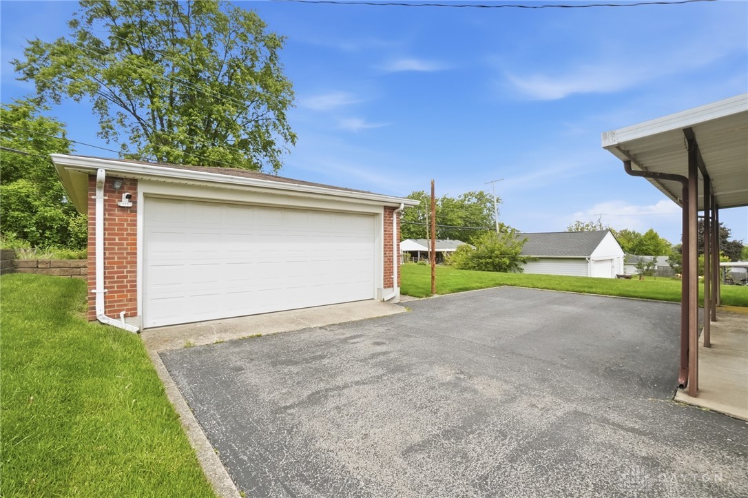 877 Woodhill Road Riverside, OH 45431 - Photo 36 of 42 This property features a spacious garage and an expansive driveway, perfect for vehicle storage and outdoor activities.