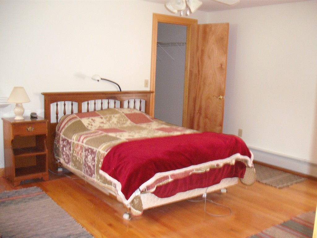 171 Maple Avenue Rutland, MA 01543 - Photo 11 of 25 a bed sitting in a bedroom next to a window