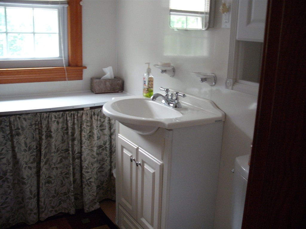 171 Maple Avenue Rutland, MA 01543 - Photo 12 of 25 a bathroom with a sink and a mirror