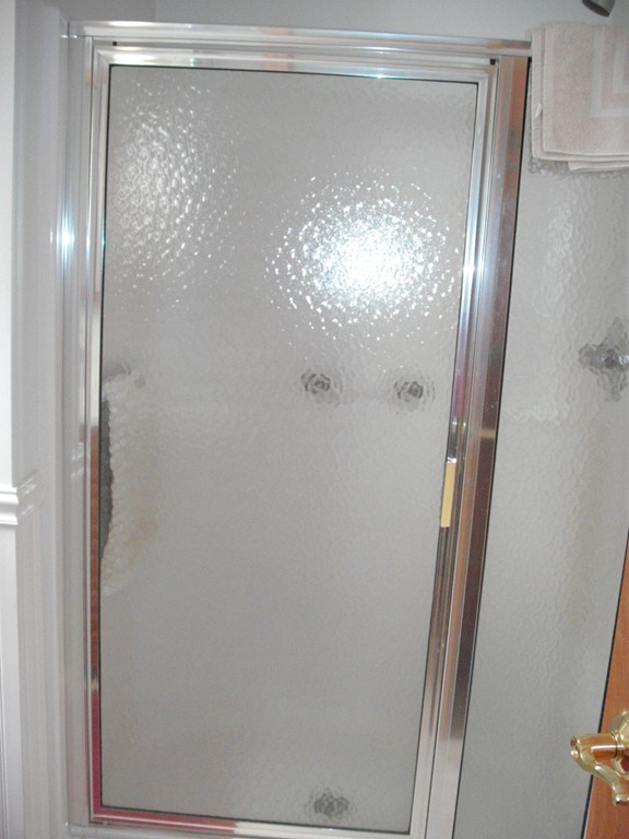 171 Maple Avenue Rutland, MA 01543 - Photo 15 of 25 a bathroom with a glass shower door