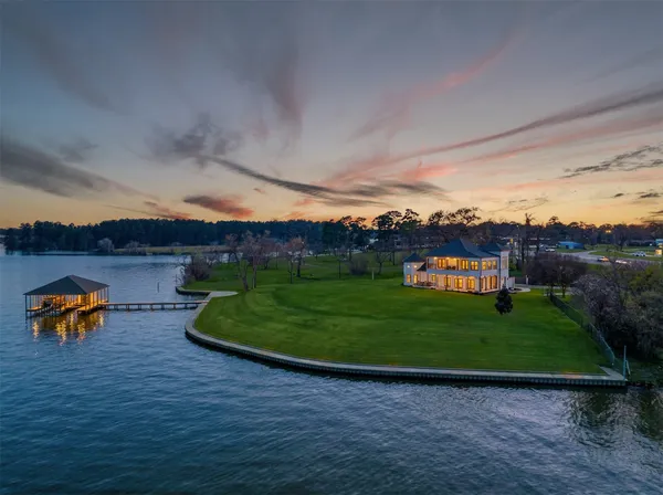 a backyard of a house with a yard and outdoor seating
