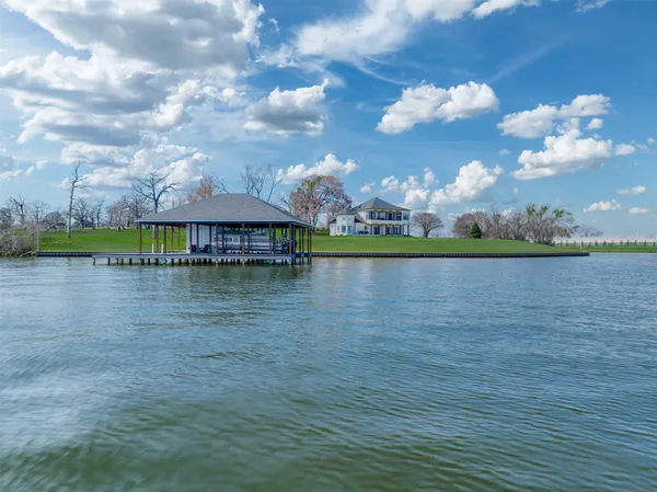 a view of a lake with houses in the background