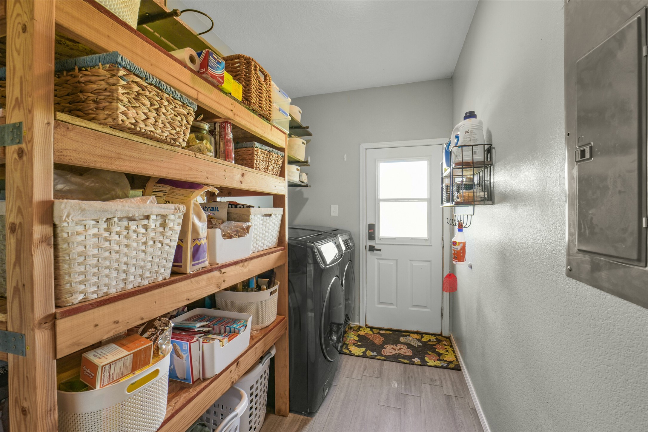 11301 South FM 441 Road El Campo, TX 77437 - Photo 16 of 43 The laundry room is located inside the home and contains wooden shelving for storage.