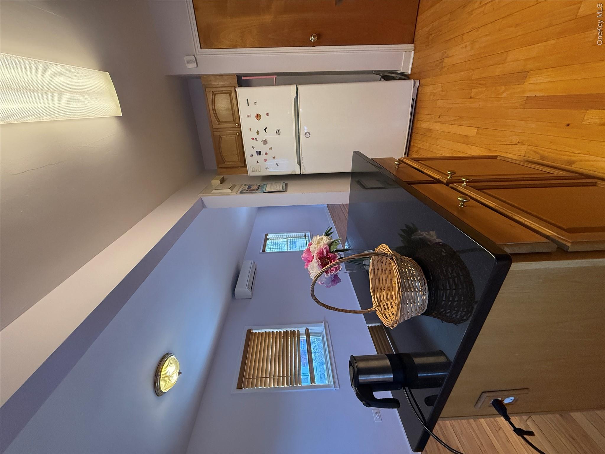 110-51 64th Road, Unit 25 Queens, NY 11375 - Photo 11 of 24 a kitchen with a table chairs and a refrigerator