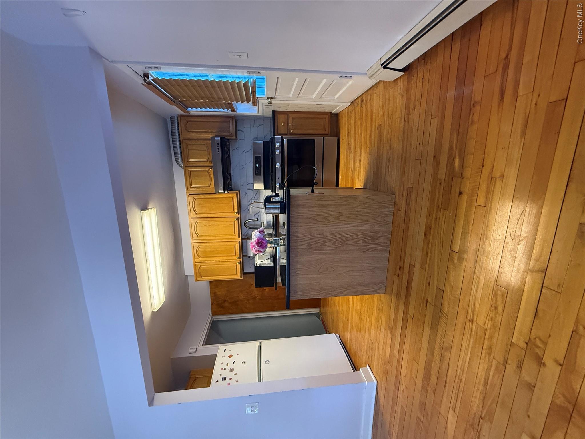 110-51 64th Road, Unit 25 Queens, NY 11375 - Photo 3 of 24 a kitchen with stainless steel appliances granite countertop a stove and a refrigerator