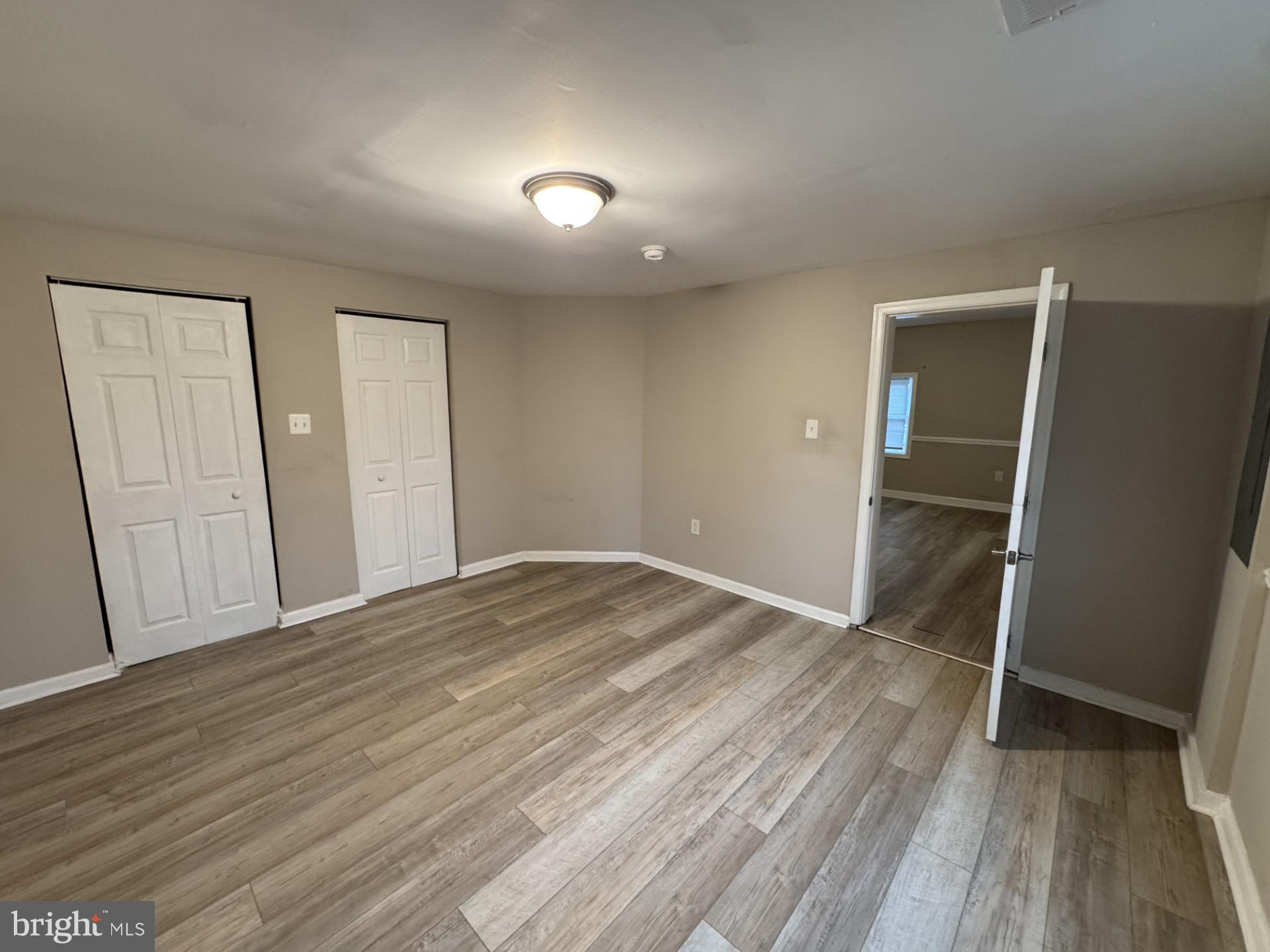 3920 Main Street, Unit A Trappe, MD 21673 - Photo 12 of 16 an empty room with wooden floor and closet