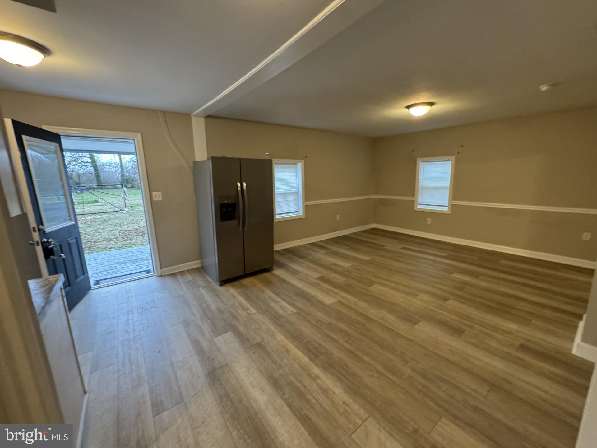 3920 Main Street, Unit A Trappe, MD 21673 - Photo 3 of 16 an empty room with wooden floor and windows