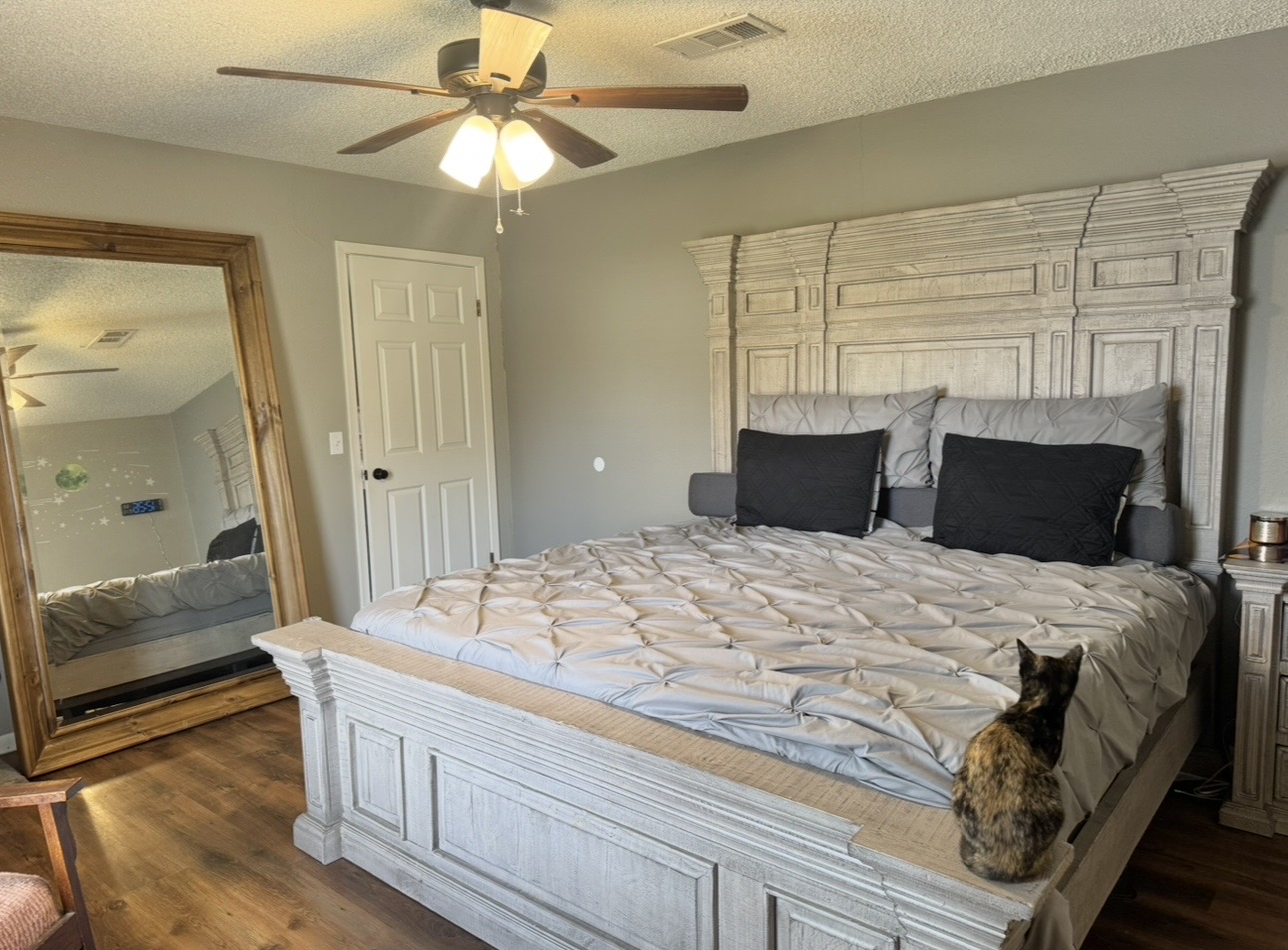 612 Cardinal Street Elgin, TX 78621 - Photo 14 of 28 Bedroom featuring a textured ceiling, dark wood-type flooring, and a ceiling fan