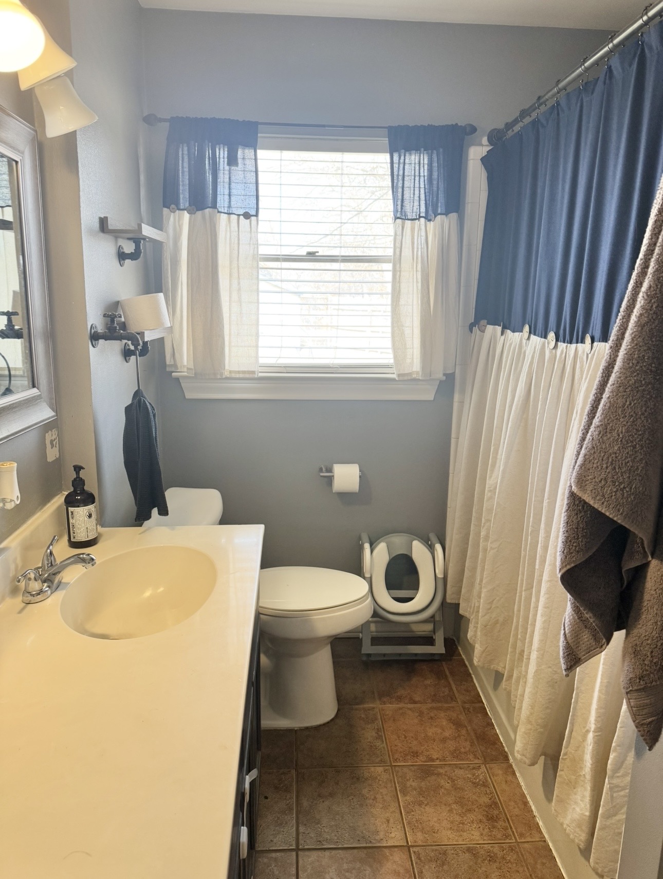 612 Cardinal Street Elgin, TX 78621 - Photo 18 of 28 Full bath featuring vanity, dark tile patterned floors, and shower / bathtub combination with curtain