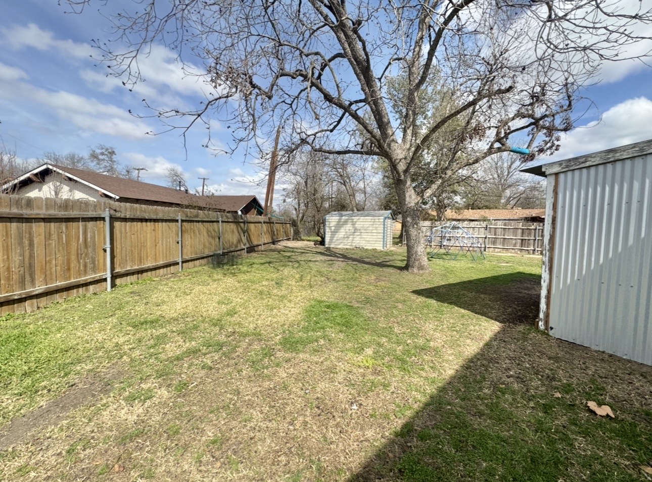 612 Cardinal Street Elgin, TX 78621 - Photo 26 of 28 Fenced backyard featuring a storage unit