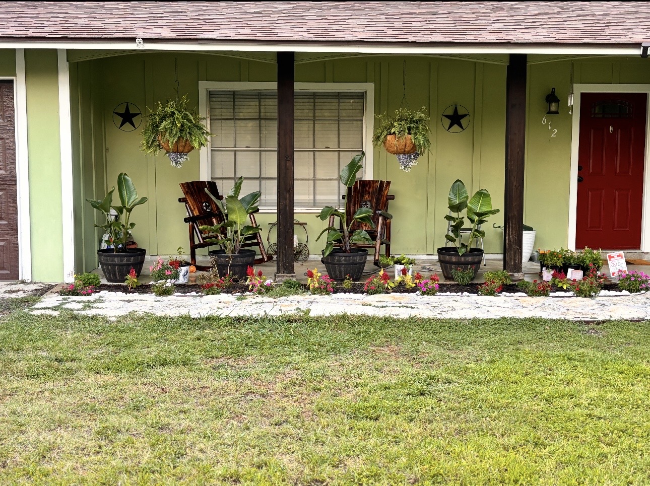612 Cardinal Street Elgin, TX 78621 - Photo 3 of 28 Doorway to property with a shingled roof, a porch, and a lawn