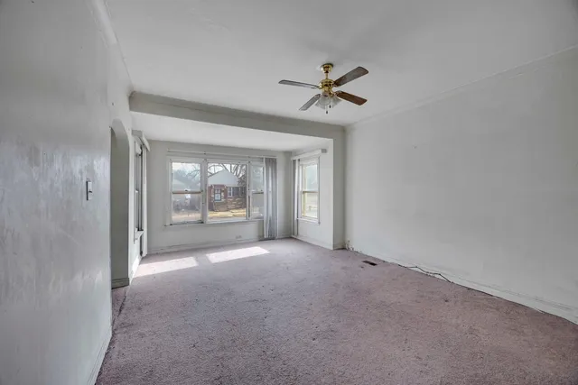 a view of a big room with windows and chandelier